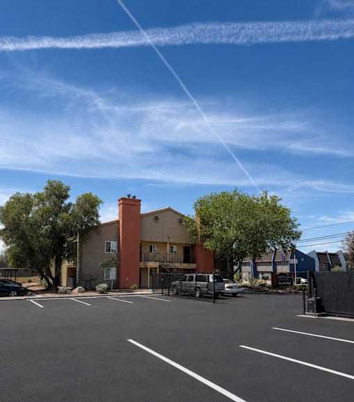 A parking lot with a building in the background.