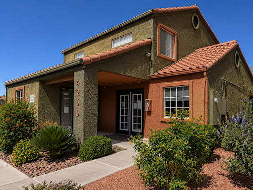 A house with a red tile roof and a brown door.