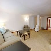 a living room with a couch a table and a chair
