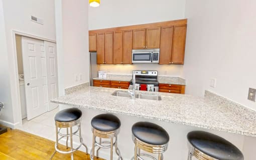 a kitchen with an island and four stools