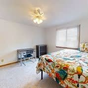a bedroom with a bed and a desk in it
