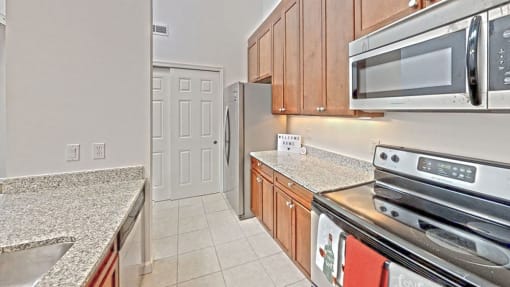 a kitchen with granite countertops and stainless steel appliances