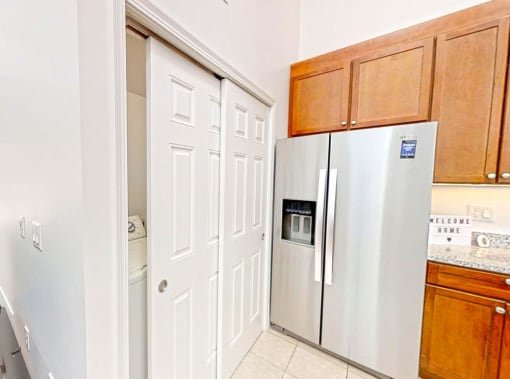 a kitchen with a refrigerator and a pantry