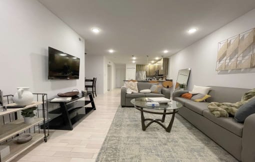 a living room with couches and a glass table
