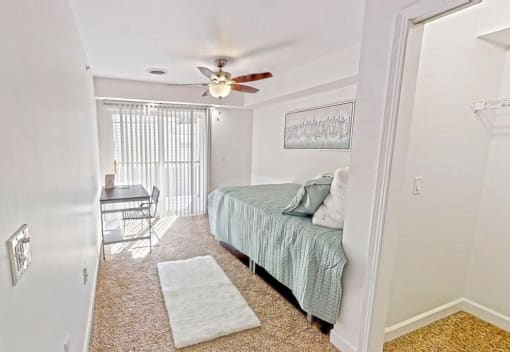 a bedroom with a bed and a ceiling fan