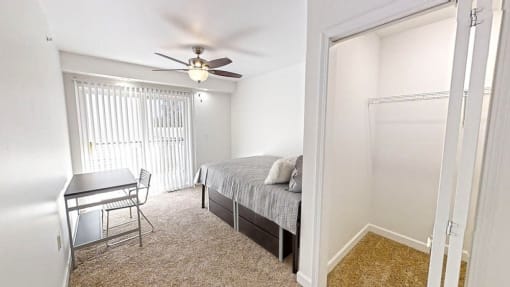 a bedroom with a bed and a desk