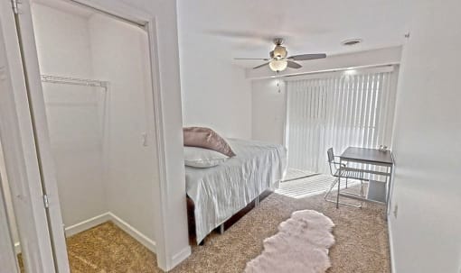a bedroom with a bed and a desk