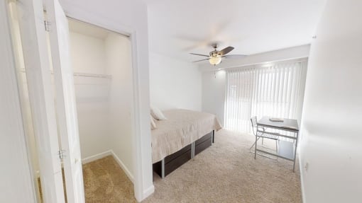 a bedroom with a bed and a desk