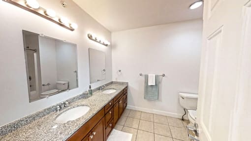 a bathroom with two sinks and a toilet