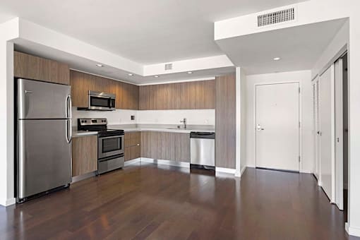 A kitchen with a refrigerator, oven, microwave, and sink. at The View, Los Angeles, CA, 90005