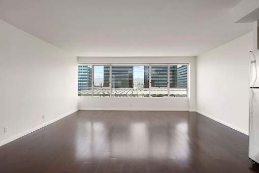 A room with a large window and wooden flooring. at The View, Los Angeles