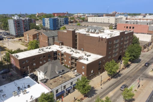 a view from above of a brick building with a white roof and a blue building behind it