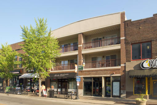 a large brick building with balconies on a city street