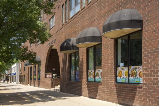 a brick building with black awnings