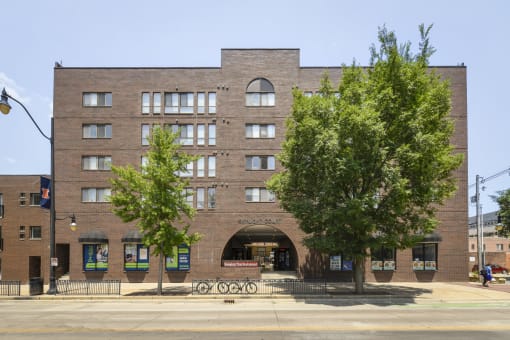 a brick building with a large arch in front of it