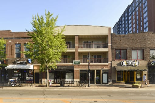 a city street with a large building in the background