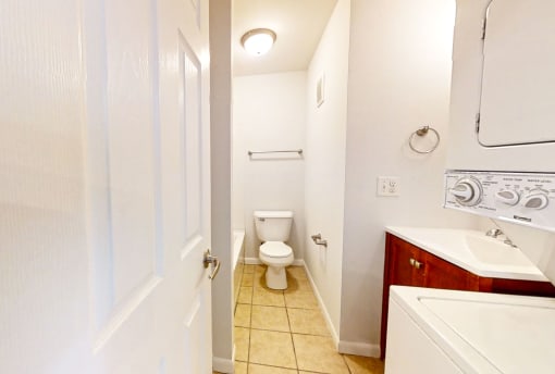 a bathroom with a toilet sink and mirror