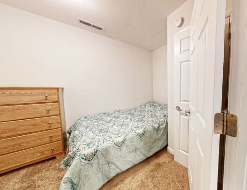 a bedroom with a bed and a dresser