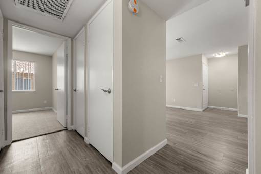 a renovated living room with white walls and wood floors