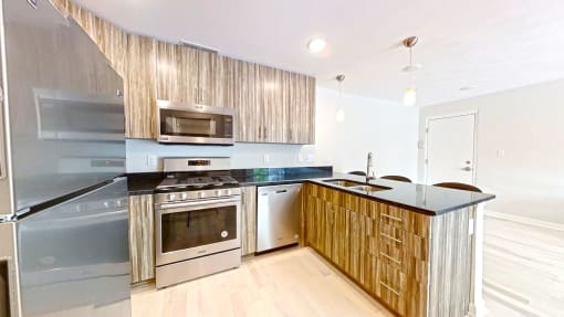 a kitchen with wooden cabinets and stainless steel appliances