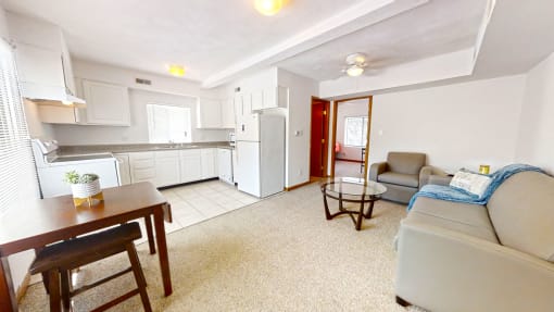 a living room with a couch a table and a chair