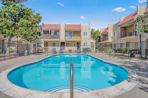 a swimming pool at an apartment building with a blue pool
