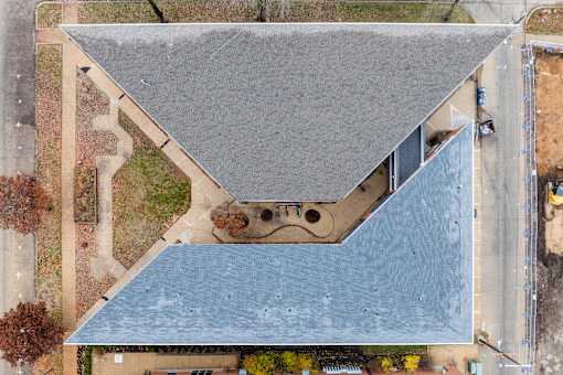 A building with a grey roof and a blue roof.