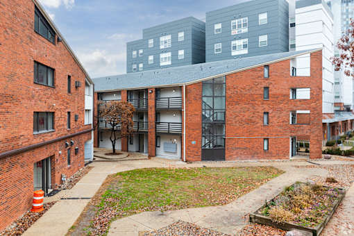 A courtyard surrounded by red brick buildings.
