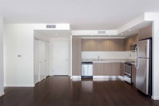 A kitchen with stainless steel appliances and wooden cabinets. at The View, Los Angeles