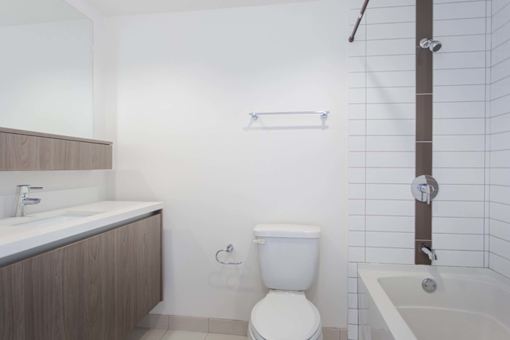 A white toilet sits next to a white sink in a bathroom. at The View, Los Angeles