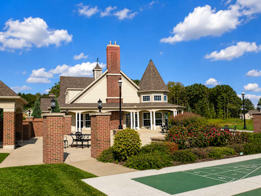 A house with a green lawn in front.