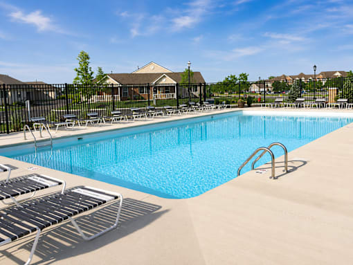 A large swimming pool surrounded by lounge chairs.