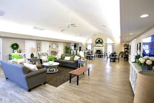 A living room with a grey couch and a wooden coffee table.