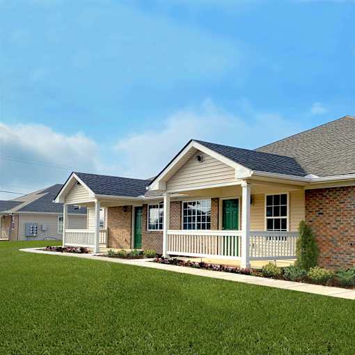 A house with a green door and a white porch.