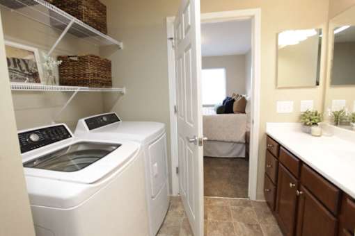 A white washing machine and dryer in a small laundry room.