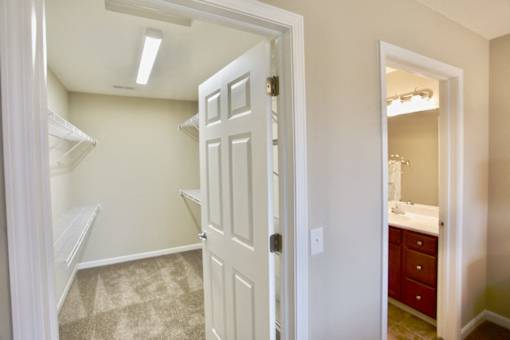 A white door is open to a bathroom.