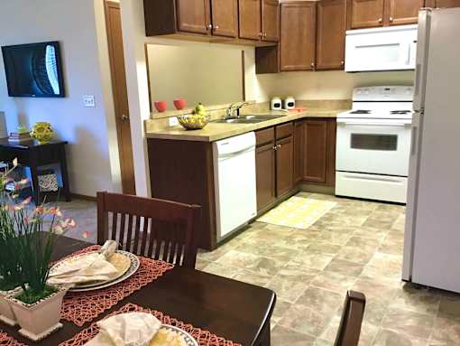 A kitchen with a table set for two.