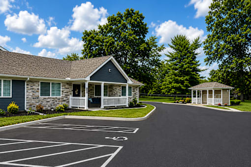 An apartment with a driveway in front of it.
