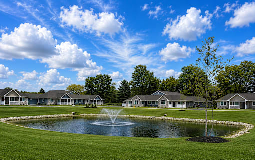 A pond in front of apartment buildings.