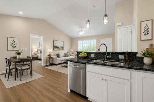A kitchen and dining area open to a living room.