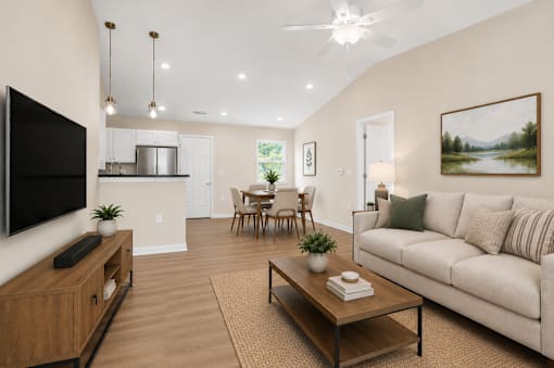A living room with a couch, a coffee table, and a television.