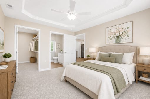 A bedroom with a large bed and a ceiling fan.