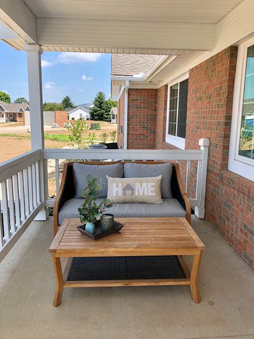A wooden table with a tray on it and a pillow with the word