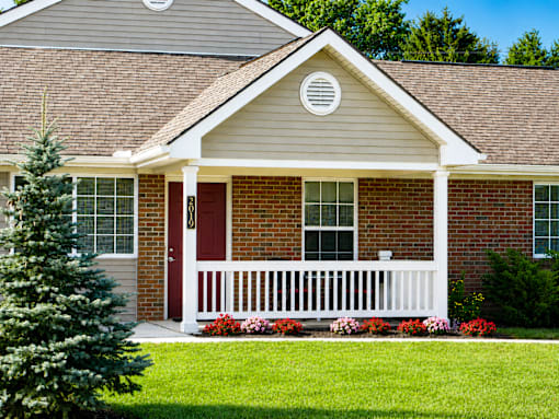 A house with a red door and white porch.