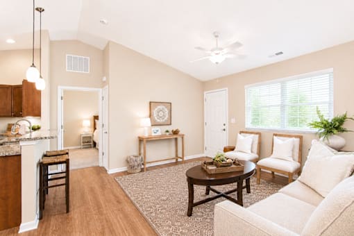 A living room with a couch, chair, and table.
