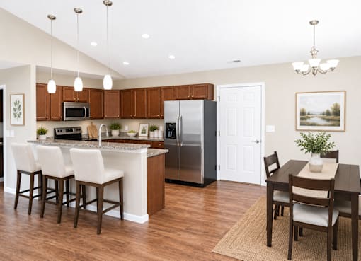 A kitchen with brown cabinets and a black refrigerator.