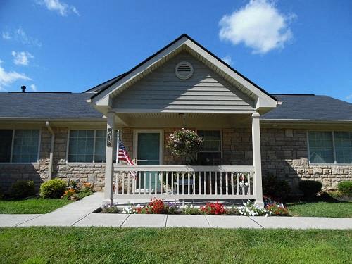 A house with a front porch and an American flag.