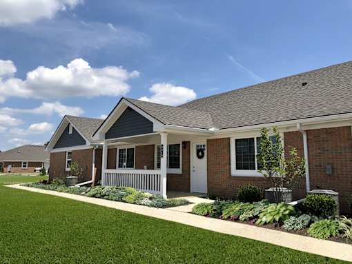 A row of houses with a well-maintained lawn in front.