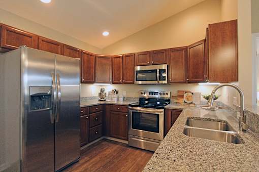A kitchen with wooden cabinets and stainless steel appliances.