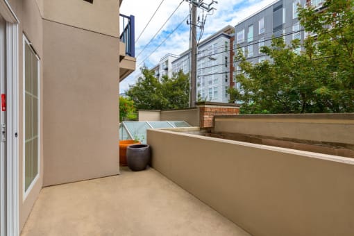 a patio with a door and a vase on it